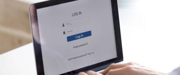 Person using access window to log in or to create new web account. Enter login and password. Cyber protection. Information privacy. Internet and technology concept. Screen close up back view